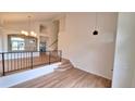 Bright living room featuring vaulted ceilings, with wood floors and open staircase at 10538 Tiger Chase, Lone Tree, CO 80124