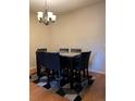 Stylish dining area with a sleek table, comfortable chairs, and modern chandelier at 14201 E 1St Dr # 104, Aurora, CO 80011