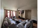 Comfortable living room with plush sofas, a ceiling fan, and a modern entertainment setup at 14201 E 1St Dr # 104, Aurora, CO 80011