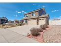 Well-maintained home with lush landscaping, stone accents, and an oversized driveway with a three car garage at 4971 Ceylon Way, Denver, CO 80249