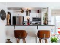 Modern kitchen featuring stainless steel appliances, white cabinetry, and sleek countertop with barstool seating at 8730 Chase Dr # 141, Arvada, CO 80003