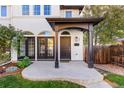 Two-story home's front entrance with covered porch at 63 Harrison St, Denver, CO 80206