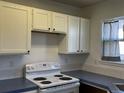 Clean kitchen with white cabinets and standard white electric range at 1339 Sumner St # B, Longmont, CO 80501