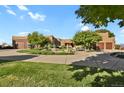 Charming circular driveway with mature landscaping leading to the beautiful home at 4719 Beverly Ln, Erie, CO 80516