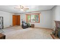 Cozy living room with a bay window offering natural light and a ceiling fan at 6050 Marshall Ct, Arvada, CO 80003