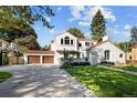 Beautiful home boasting a well-maintained lawn, an inviting driveway, and a detached garage with a basketball hoop at 521 N Fairfax St, Denver, CO 80220