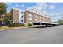 Apartment building with covered parking and surrounding landscaping at 384 S Ironton St # 413, Aurora, CO 80012