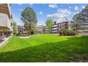 Well-manicured lawn with landscaping and apartment buildings in the background at 384 S Ironton St # 413, Aurora, CO 80012