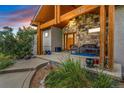Inviting stone-accented front porch with wood beams and cozy seating area at 17635 Silver Fox Ct, Mead, CO 80542