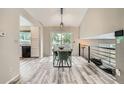 Dining area features a modern table, chairs, and a sliding glass door to the outdoors at 11481 King St, Westminster, CO 80031