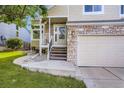 Inviting front entrance with stone accents, a covered porch, and a glass-paneled front door at 11481 King St, Westminster, CO 80031