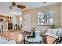 Inviting living room with hardwood floors, ceiling fan, and ample natural light at 2280 W Center Ave, Denver, CO 80223