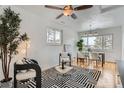 Bright living room with hardwood floors, ceiling fan, and ample natural light at 2280 W Center Ave, Denver, CO 80223