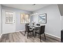 Charming dining room featuring a glass table, modern lighting, and a window with natural light at 3423 Madison Ave # X133, Boulder, CO 80303