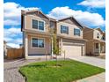 Two-story house with beige siding, gray shutters, and a two-car garage at 2236 Crosswind St, Fort Lupton, CO 80621
