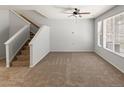 Living room area with neutral paint, carpet flooring and natural light from large windows at 619 S Norfolk Way, Aurora, CO 80017