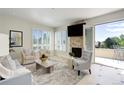 Elegant living room with large windows, cozy seating, and balcony access at 2500 E Cherry Creek South Dr # 306, Denver, CO 80209