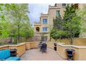 Relaxing outdoor patio with seating area, table, chairs, retaining wall, and mature trees at 2500 E Cherry Creek South Dr # 306, Denver, CO 80209