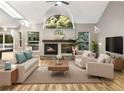 Well-lit living room featuring a fireplace, comfortable seating, and a large arched window that streams in natural light at 7873 Sweet Water Rd, Lone Tree, CO 80124