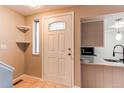 Inviting entryway featuring a white front door with glass panel and tile flooring at 2479 S Xanadu Way # C, Aurora, CO 80014