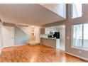 Bright living room with wood floors, neutral walls and direct access to the kitchen at 2479 S Xanadu Way # C, Aurora, CO 80014