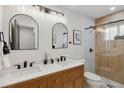 Beautiful bathroom featuring double sinks, modern fixtures, and a glass-enclosed shower at 2812 N Harrison St, Denver, CO 80205