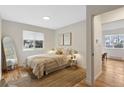 Cozy bedroom with a neutral color palette, a large window, and hardwood floors at 2812 N Harrison St, Denver, CO 80205
