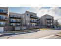 Apartment building with stone and siding, showcasing outdoor patio and balcony spaces at 6000 W Floyd Ave # 307, Denver, CO 80227
