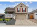 Inviting two-story home with a covered porch and a well-maintained landscaped front yard at 4592 Malaya St, Denver, CO 80249