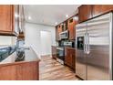 Well-equipped kitchen with stainless steel appliances, dark cabinetry, and sleek black countertops at 3762 S Fenton Way, Denver, CO 80235