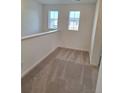 Upstairs hallway area with carpet, white trim, and two windows for plenty of natural light at 15277 Fillmore St, Thornton, CO 80602
