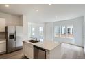 Bright, open concept kitchen with stainless steel appliances and spacious island at 15277 Fillmore St, Thornton, CO 80602