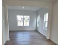 Bright living room with hardwood floors, recessed lighting, and large windows offering natural light at 15277 Fillmore St, Thornton, CO 80602