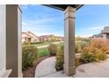View from front porch showing manicured landscaping and community pathway at 12638 Monroe Dr, Thornton, CO 80241