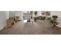 Bright living room with a comfortable couch and a sliding glass door for balcony access at 9300 E Center Ave # 2B, Denver, CO 80247