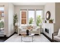Bright living room with a fireplace, large windows and a comfortable seating area at 1932 W 32Nd Ave, Denver, CO 80211