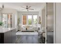 Open concept living room featuring a fireplace, large windows, and hardwood floors at 1932 W 32Nd Ave, Denver, CO 80211