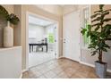 Welcoming foyer with neutral tones, tile floors, and front door with decorative glass, offering a glimpse into the office at 2601 Pemberly Ave, Highlands Ranch, CO 80126