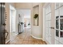 Inviting foyer with tile flooring, an arched niche, and a view into the dining area creating an open and airy atmosphere at 2601 Pemberly Ave, Highlands Ranch, CO 80126