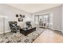 Cozy living room with bay window, stylish furnishings, and modern light gray wall paint at 5426 S Jasper Way, Centennial, CO 80015