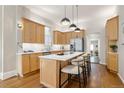 Modern kitchen features stainless steel appliances, a large island, and beautiful light wood cabinets at 2355 N Emerson St, Denver, CO 80205