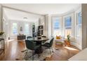 Bright living room featuring hardwood floors, large windows, and an elegant dining table at 2355 N Emerson St, Denver, CO 80205
