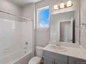 Bright bathroom with a shower-tub combination and vanity with a large mirror at 17557 E 89Th Way, Commerce City, CO 80022