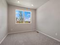 Bedroom with a window, plush carpet, and neutral walls, creating a serene atmosphere at 17557 E 89Th Way, Commerce City, CO 80022
