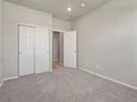Bedroom with neutral walls, carpeted floors and a closet with white doors at 17557 E 89Th Way, Commerce City, CO 80022