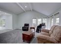 Spacious living room featuring vaulted ceilings, carpet, and large windows for lots of natural light at 7715 S Hudson Ct, Centennial, CO 80122