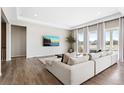 Bright living room with ample seating, large windows, and access to an outdoor patio area at 21894 E Tufts Cir, Aurora, CO 80015