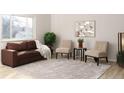 Cozy living room featuring modern furniture, light colored walls, and a large window at 1731 S Naples St, Aurora, CO 80017