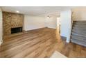 Spacious living room with hardwood floors and a brick fireplace at 1772 Robb St, Lakewood, CO 80215