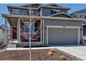 Charming two-story home with a well-manicured front yard and inviting front porch, perfect for relaxing outdoors at 3953 John Ave, Castle Rock, CO 80104